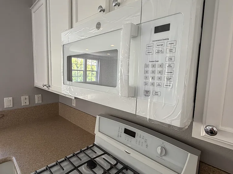 Well-appointed kitchen featuring a brand-new microwave and built-in AquaTru reverse osmosis water filtration system.