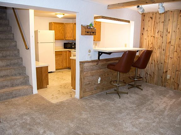 Stairway, kitchen entry, bar.