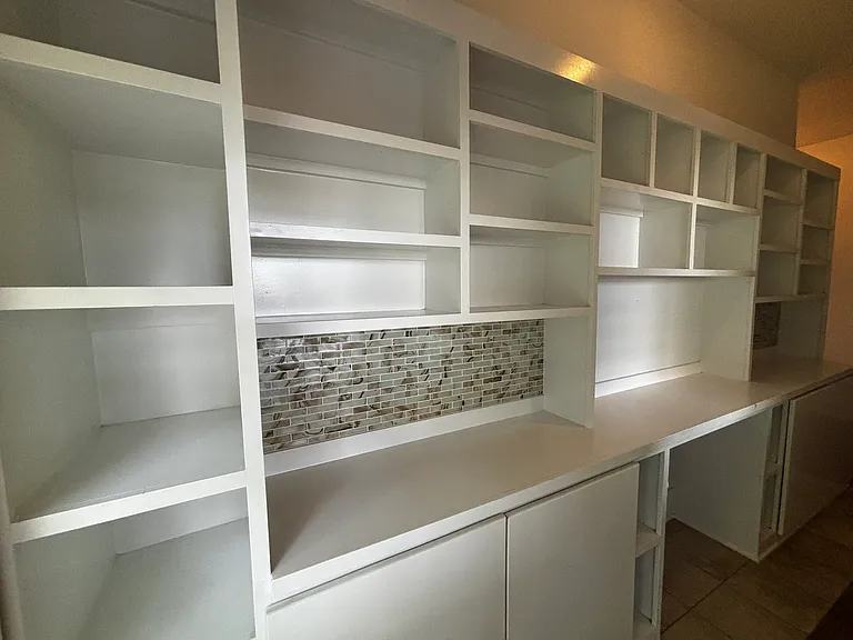 Office built-in office with desk and ample storage for books.