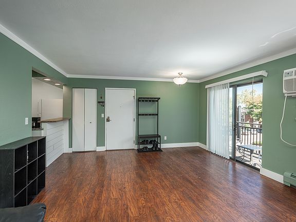 Open living room and dining area with laminate flooring.