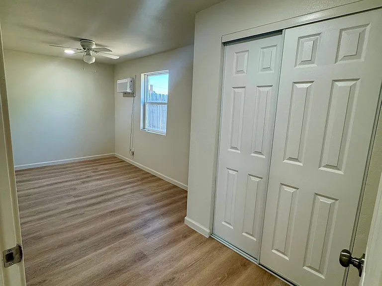 New window, ceiling fan, and wall AC/Heater unit.