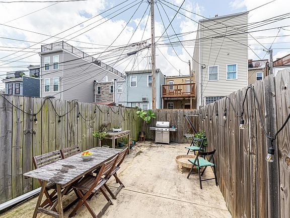 Lighted large rear Patio with room for grill and plenty of seating. Wonderful for entertaining!