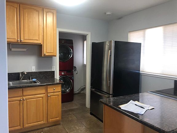Kitchen connects to a laundry room which also has back door to the private fenced backyard.