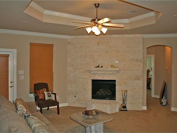Family Room features a lovely fireplace, trey ceiling, and French door to the screened in back porch.