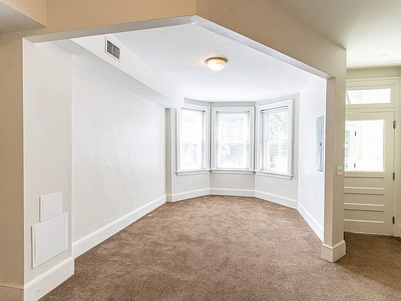 A view of the living room with its three large windows lets in a maximum amount of light.