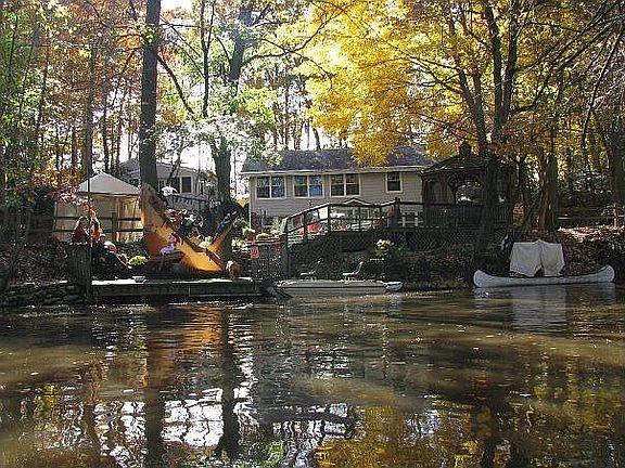 View from creek: Detached Garage with Workshop, House, Dock, Deck and Gazeebo
