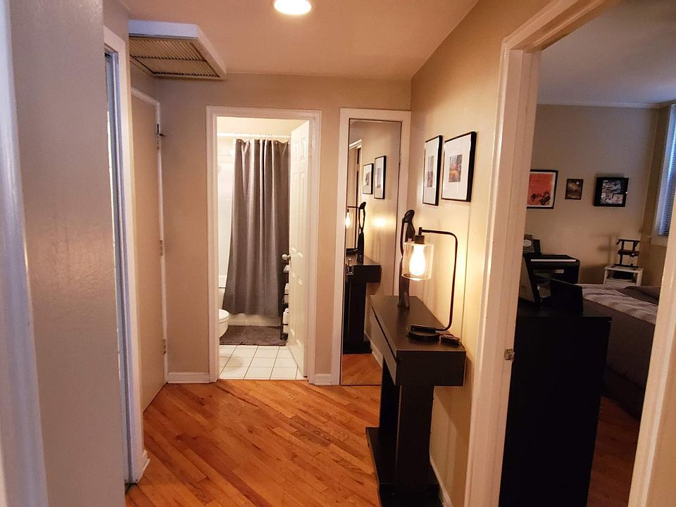 Fyer looking into the bedroom and bathroom, full length mirrors on linen and coat closet doors.