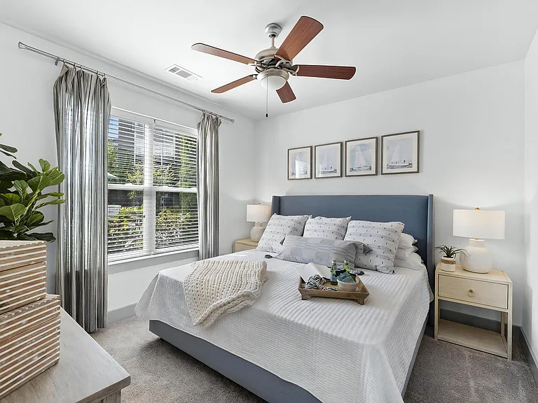 Spacious Bedroom with Ceiling Fan and Plush Carpeting