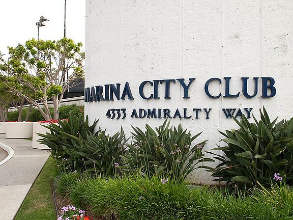 Entrance to community with sign that reads Marina City Club.