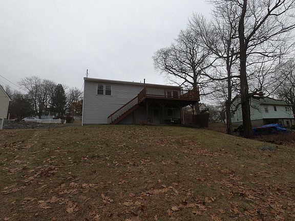 Back yard, long view of rear of house and deck