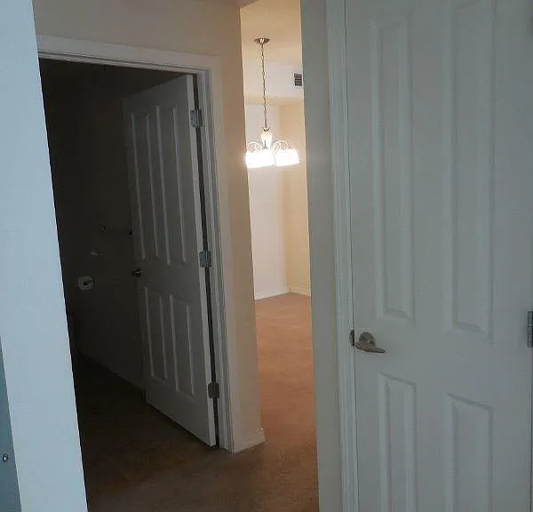 Hallway to second bath and closet with shelving