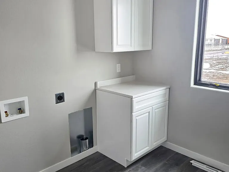 Welcome to Paradise Valley Townhomes, where modern design meets functionality. This stunning laundry space offers sleek cabinetry and abundant natural light, making chores a breeze. Schedule your tour today to see your new home!