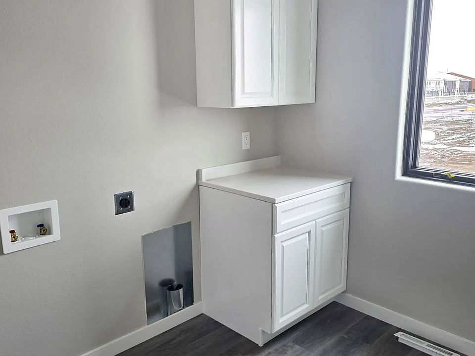 Welcome to Paradise Valley Townhomes, where modern design meets functionality. This stunning laundry space offers sleek cabinetry and abundant natural light, making chores a breeze. Schedule your tour today to see your new home!