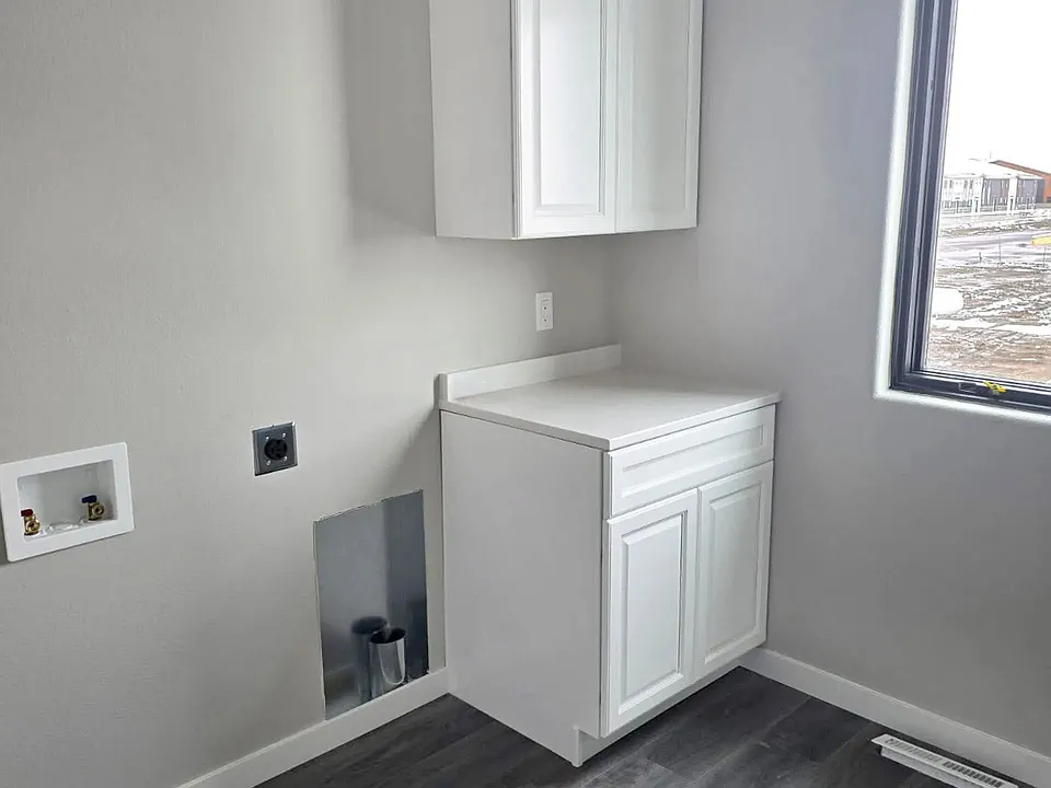 Welcome to Paradise Valley Townhomes, where modern design meets functionality. This stunning laundry space offers sleek cabinetry and abundant natural light, making chores a breeze. Schedule your tour today to see your new home!