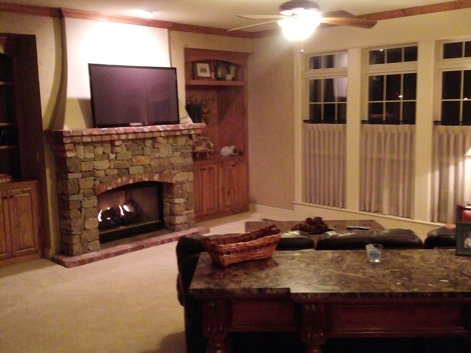 Den+stacked stone fireplace