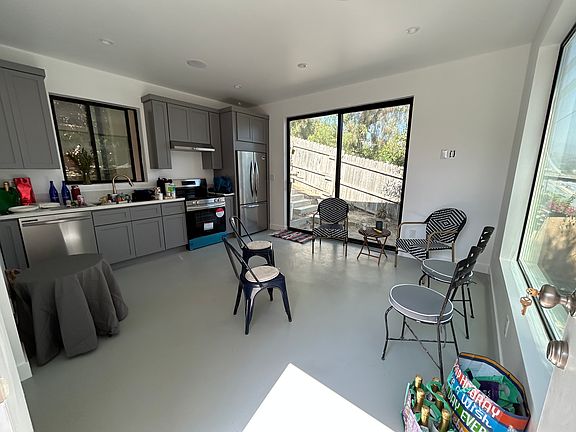 Sliding doors off the living room and open kitchen lead to a brick patio and steps that go up to the enormous rooftop deck! You must see it to really experience the charm!
