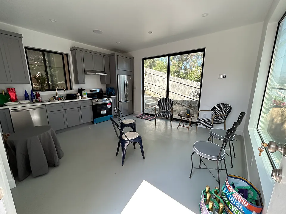 Sliding doors off the living room and open kitchen lead to a brick patio and steps that go up to the enormous rooftop deck! You must see it to really experience the charm!