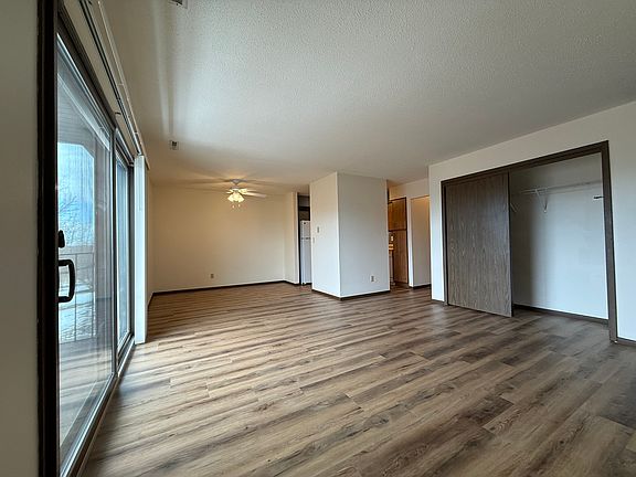 Patio door, dining room, kitchen area and coat closet in the living room