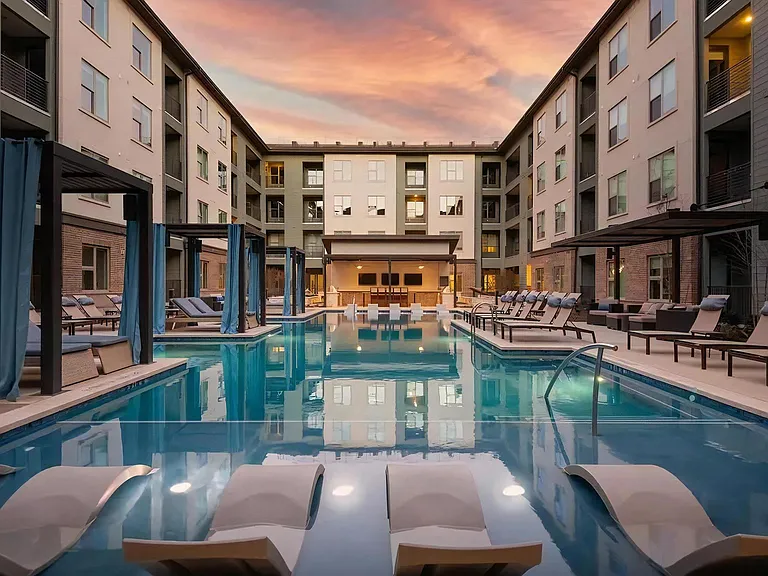 Peaceful Sunset Over Courtyard Pool Featuring Lounge Seating and Cabanas