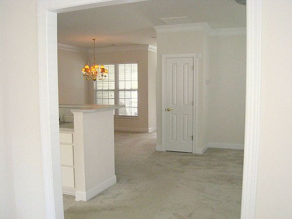 Living room flows into dining and kitchen