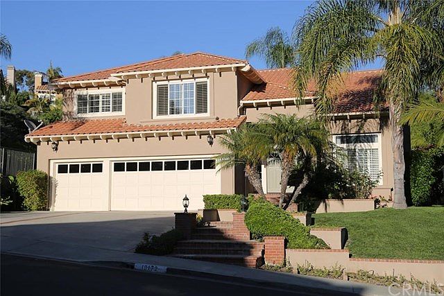 Beautiful large home on a quiet street with cement tile roof and 3 car garage, custom hardscape and landscape.