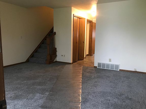 Hall to 1/2 bath, kitchen and steps down to full basement. Stairs up to 2 bedrooms, full bath and hall closet