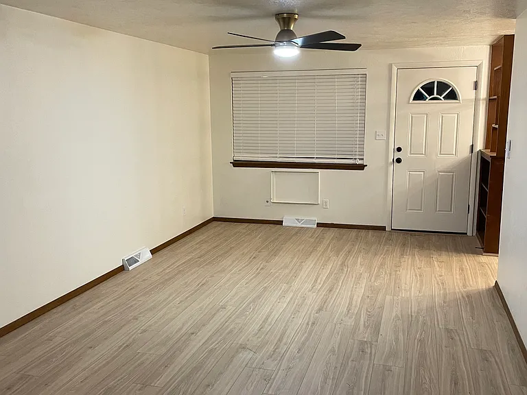 Living area: new floors and new window shades.