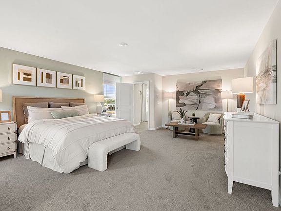 Relax and unwind after a long day in the primary bedroom.