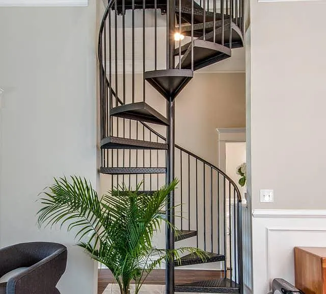 Spiral staircase up to Bedroom 2 with a sitting area