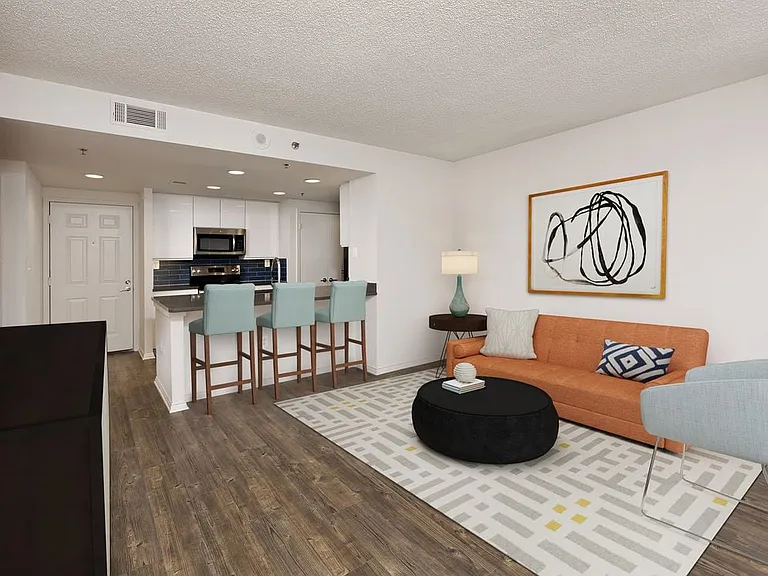Renovated Package III kitchen with grey quartz countertops, blue tile backsplash, white cabinetry, stainless steel appliances, and hard surface plank flooring