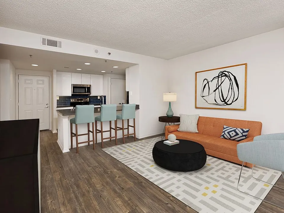 Renovated Package III kitchen with grey quartz countertops, blue tile backsplash, white cabinetry, stainless steel appliances, and hard surface plank flooring