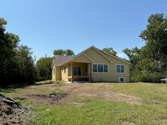 Back view of house with covered deck, still working on... ready in September! Nice private lot, with trees and beautiful view in back!