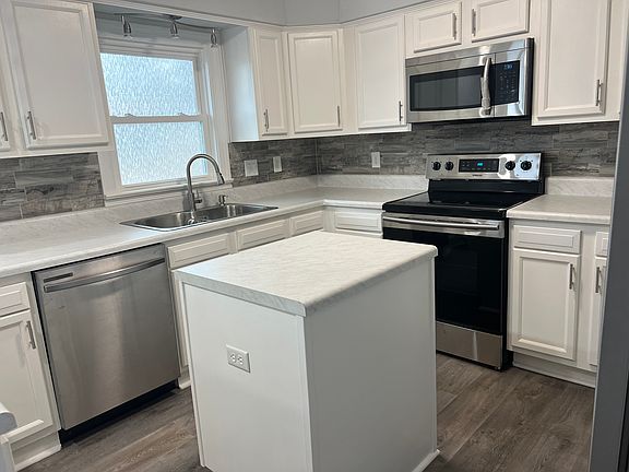 Center island with electric outlet for food prep.