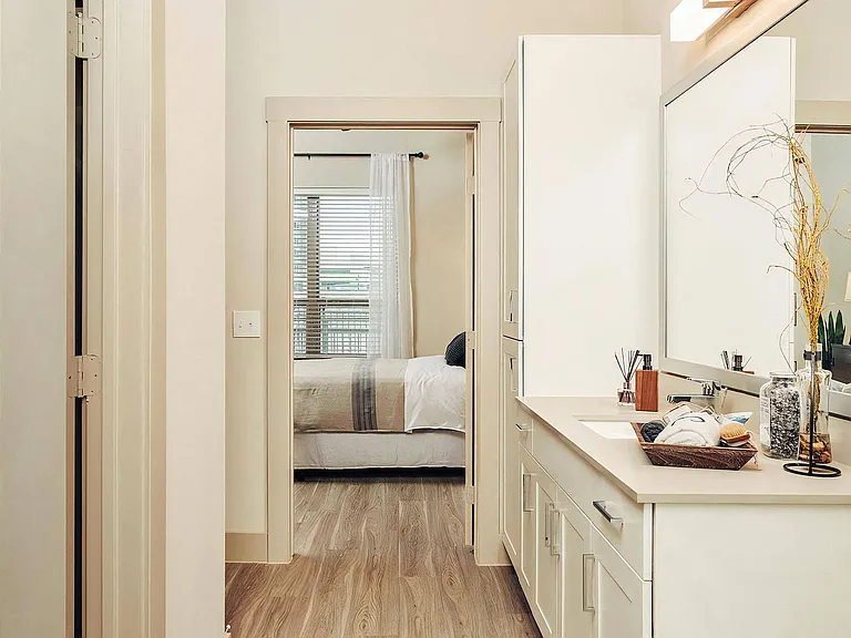 Spacious Ensuite Bathroom with Large Mirror and Modern Cabinetry