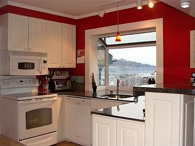 Bright, clean modern kitchen with beautiful granite counters. Large clear workspace just outside the