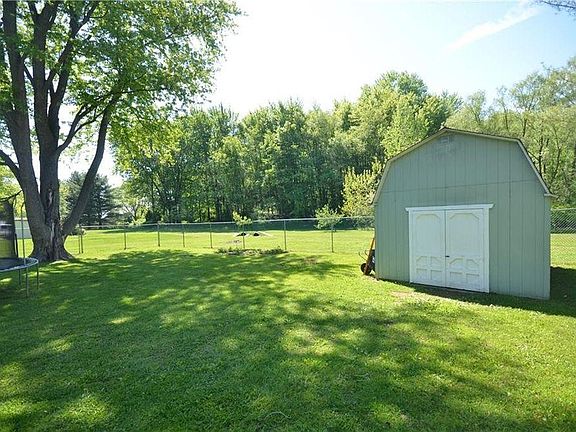 Fenced yard with large shed