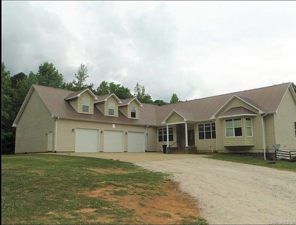 Front of House, with 3 door garage large enough for 6 cars.