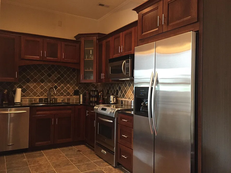 The kitchen features stainless appliances, garbage disposal, natural granite countertops, slate backsplash and an eat at bar suitable for two (not pictured).
