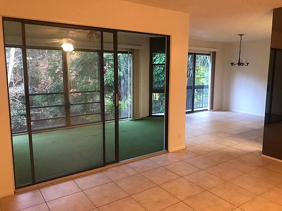 Spacious living room and dining room overlooking lanai and water view