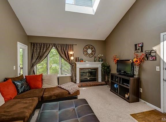 Living room with the skylight and vaulted ceiling...lots of ligh