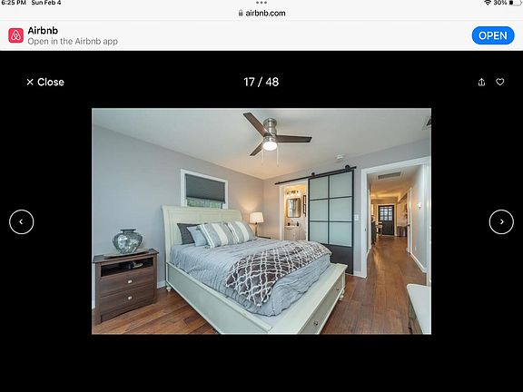 Master bedroom upstairs with a bathroom with a sliding barn door style.