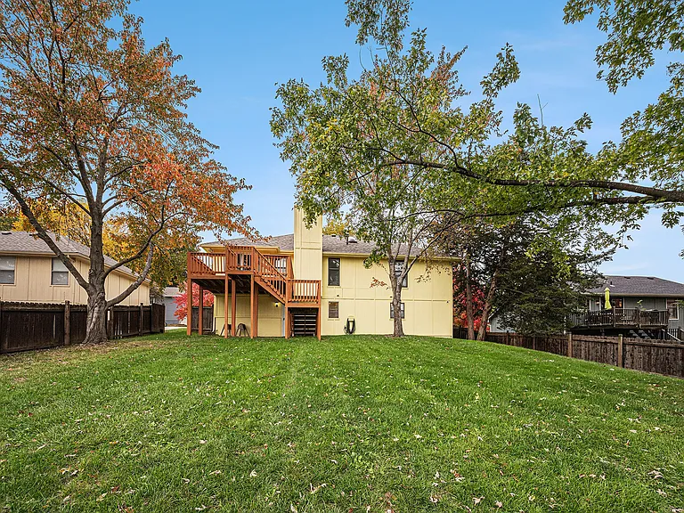 A generous backyard with well-kept grass offers room to unwind, entertain, or enjoy fresh air in a serene, open outdoor space.