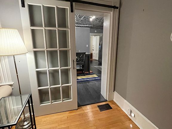Unique features enable privacy between areas within the home like this Barn Door separating the living room from the kitchen