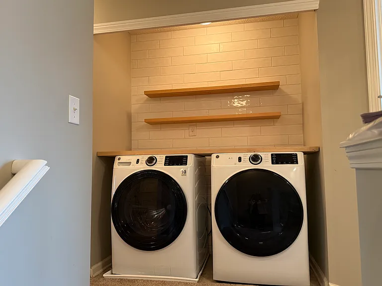 The upstairs laundry is extremely convenient and boasts a brand new GE washer and dryer set.