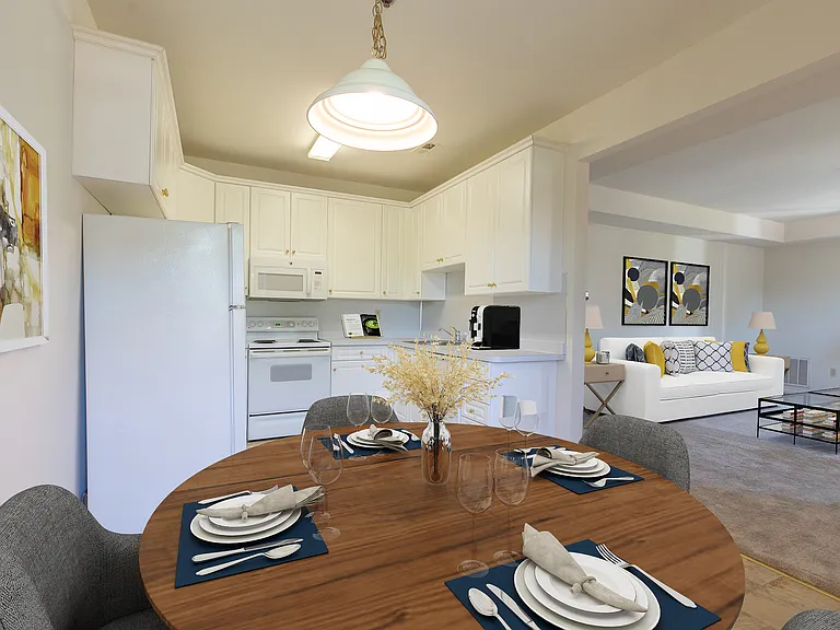 White kitchen cabinetry and GE appliances and breakfast nook.