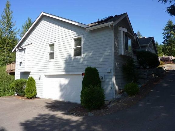 Side view shows double garage with extra work area.
