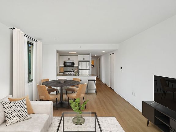 Renovated Package I dining and living room with hard-surface flooring