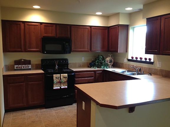 Large kitchen with pantry.  Refrigerator, microwave, stove, 