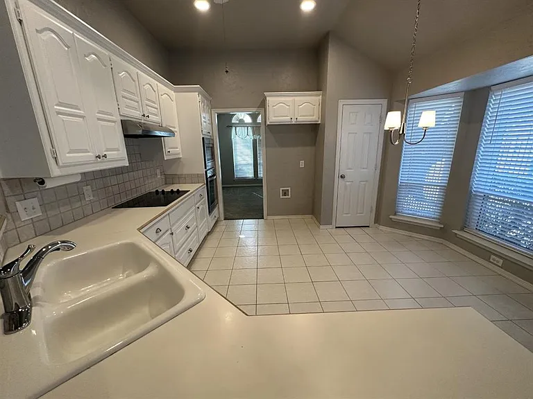 Big kitchen with room for table, pantry and lots of cabinets. Very light and bright.