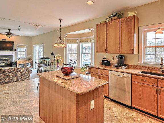 Kitchen features Island and Granite